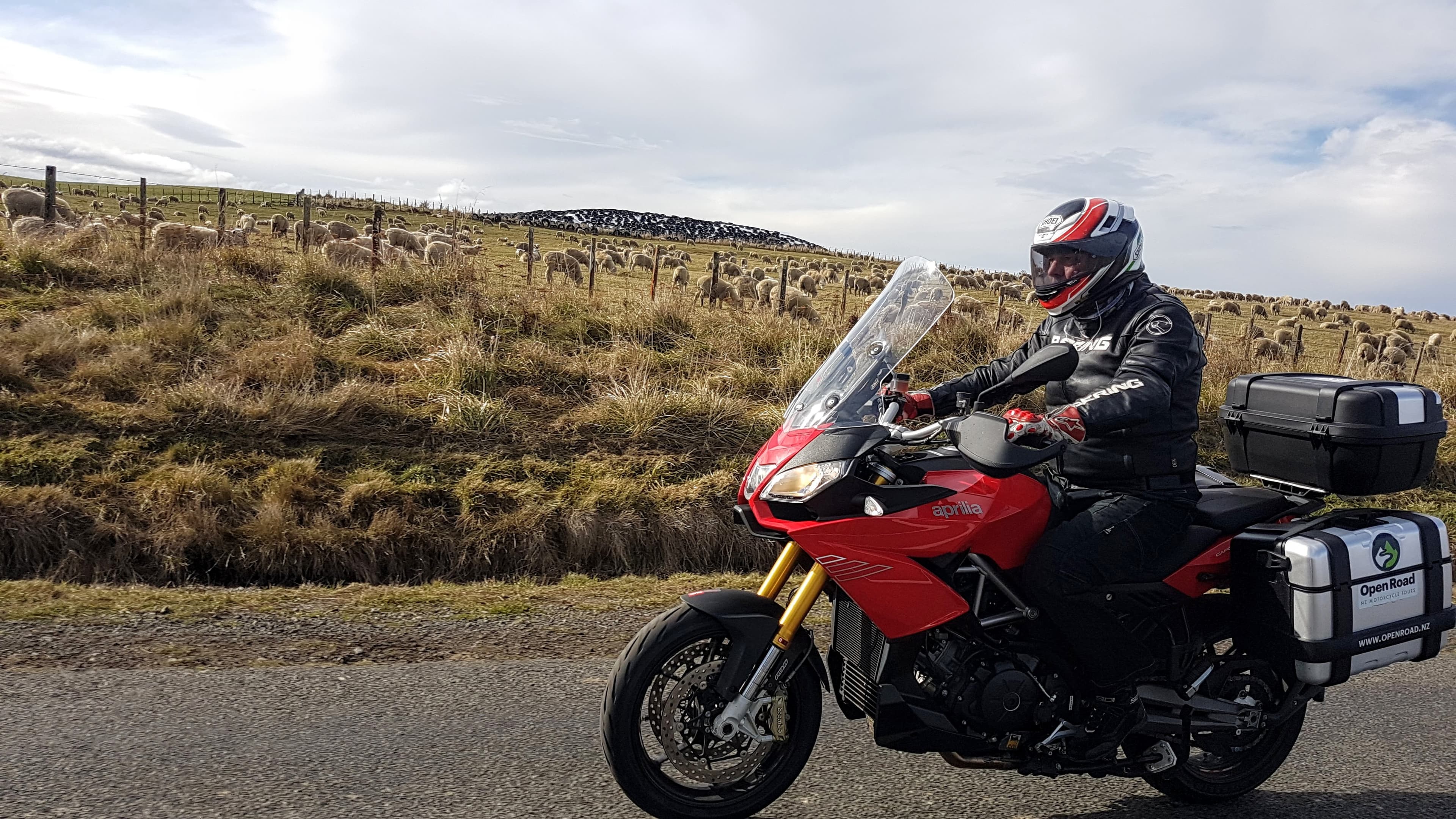 Motorcycle tour guide with two bikes in front of a lake