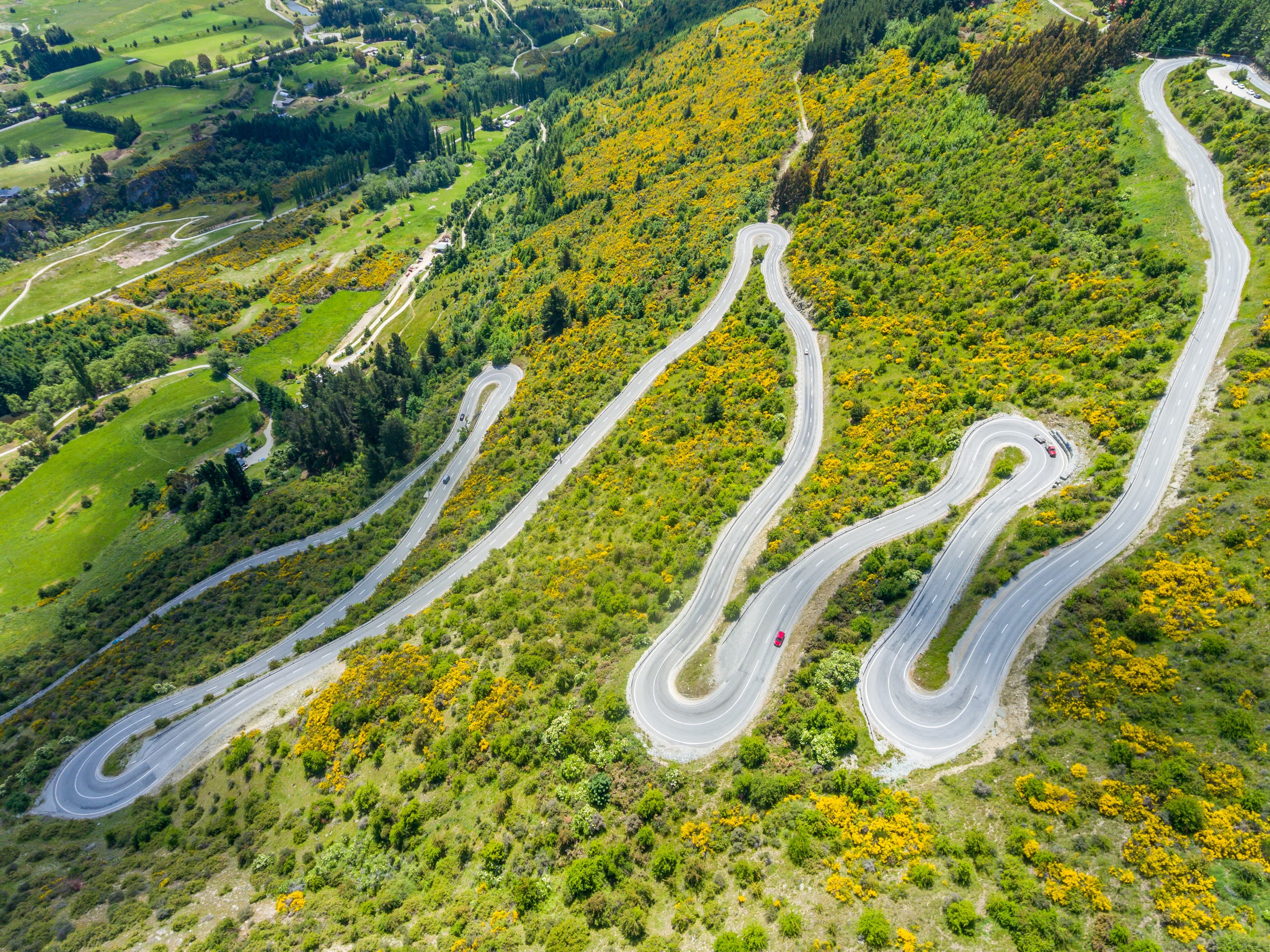 Windy road with a motorcycle in the distance